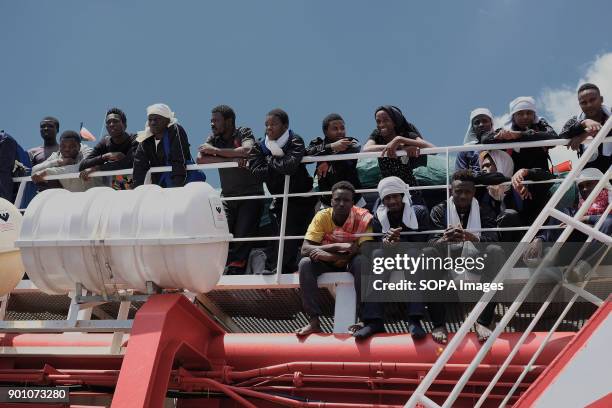 African refugees seen waiting to leave from the ship after being rescued. About 1500 african refugees land in Naples from Vos Prudence, a rescue boat...