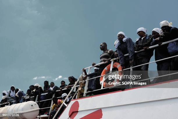 African refugees seen waiting to leave from the ship after being rescued. About 1500 african refugees land in Naples from Vos Prudence, a rescue boat...