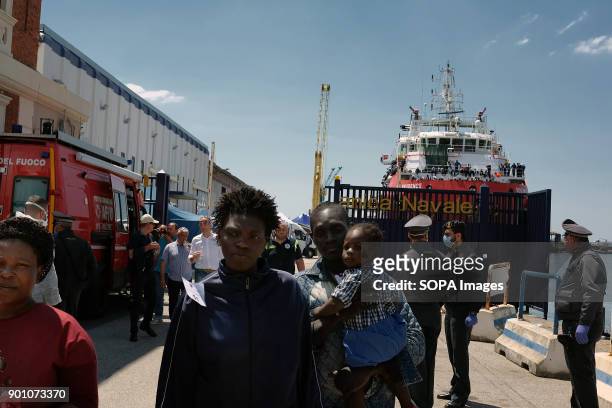 African refugees seen leaving from the ship after being rescued. About 1500 african refugees land in Naples from Vos Prudence, a rescue boat of...