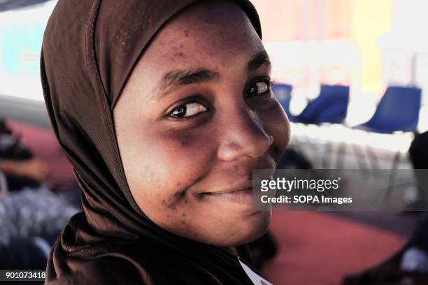 Young african woman seen smiling after being rescued as about 1500 african refugees land in Naples from Vos Prudence, a rescue boat of Medecins Sans...