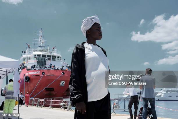 Young woman waits for first aid after have been landed in Naples from Vos Prudence, a rescue boat of Msf. About 1500 african refugees land in Naples...