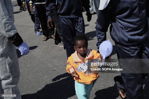Young African child seen walking as about 1500 african refugees land in Naples from Vos Prudence, a rescue boat of Medecins Sans Frontieres. On May...