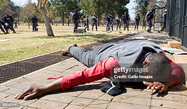 An injured protestor collapses after being hit by a rubber bullet, after police opened fire on protesting soldiers participating in an illegal march...