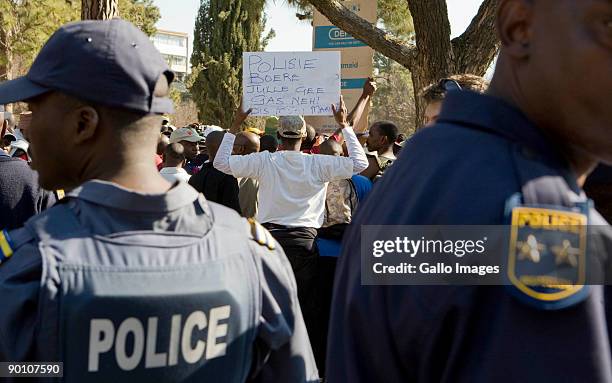 South African Police keep a watchful eye on protesting soldiers participating in an illegal march at the Union Buildings August 26, 2009 in Pretoria,...