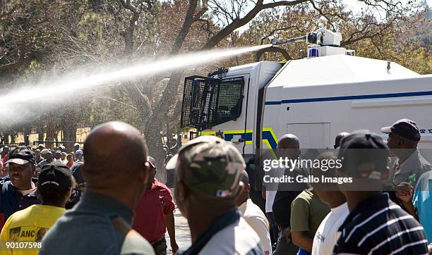 South African Police use a water cannon on protesting soldiers participating in an illegal march at the Union Buildings August 26, 2009 in Pretoria,...