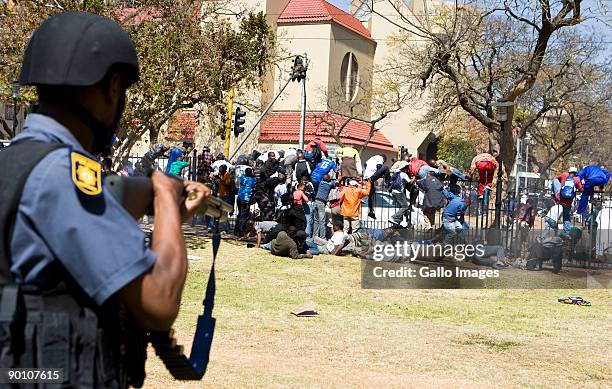 South African Police open fire on protesting soldiers participating in an illegal march at the Union Buildings August 26, 2009 in Pretoria, South...