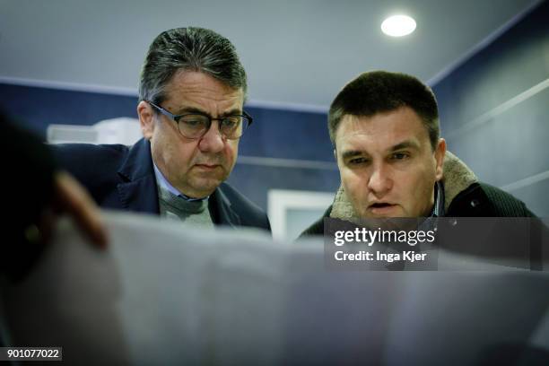 German Foreign Minister Sigmar Gabriel and the Foreign Minister of Ukraine, Pavlo Klimkin, look at a map of Ukraine at the airport, on January 04,...