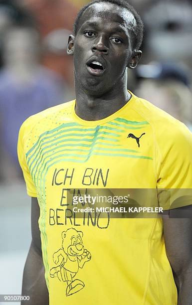 Jamaica's Usain Bolt wears a t-shirt reading "I am a Berlino" refering to the mascot after winning the men's 200m final race of the 2009 IAAF...