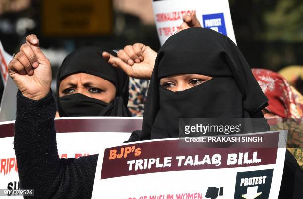 Activists of Women India Movement shout slogans as they hold placards against proposed 'Triple Talaq Bill' during a protest in New Delhi on January...