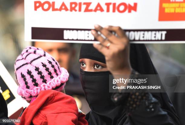 Activists of Women India Movement shout slogans as they hold placards against proposed 'Triple Talaq Bill' during a protest in New Delhi on January...