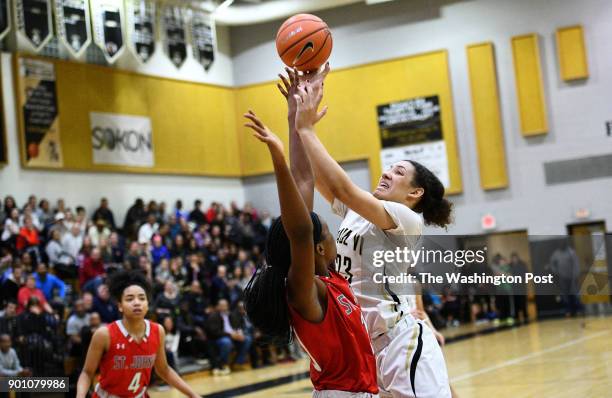 Paul VI Panthers forward Amira Collins attempts to shoot over St. John's Cadets center Malu Tshitenge-Mutombo late in the second half January 03,...