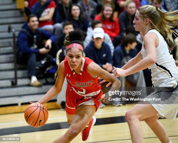 St. John's Cadets guard Sydney Wood drives past Paul VI Panthers guard Kate Klimkiewicz in the first half January 03, 2018 in Fairfax, VA. The St....