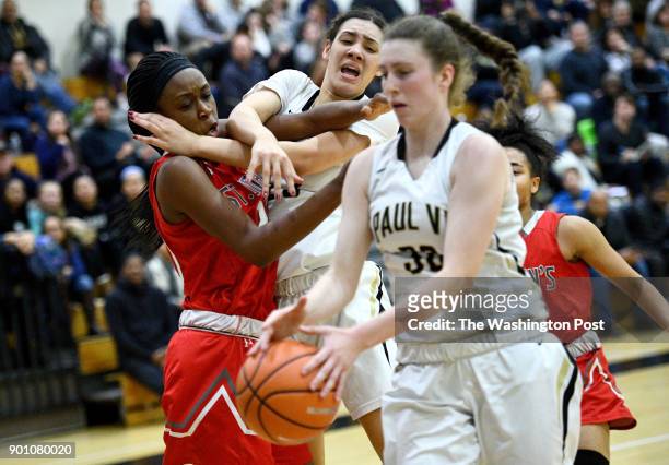 Paul VI Panthers forward Meghan Kenefick snags the loose ball ahead of St. John's Cadets center Malu Tshitenge-Mutombo and Paul VI Panthers forward...
