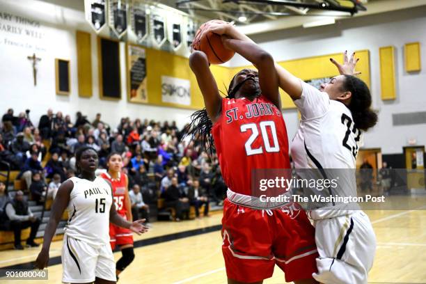 Paul VI Panthers forward Amira Collins fouls St. John's Cadets center Malu Tshitenge-Mutombo as she goes up for two in the first half January 03,...