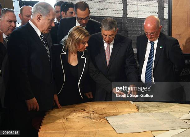 Israeli Prime Minister Benajmin Netanyahu looks at original construction plans of the Auschwitz and Auschwitz-Birkenau death camps with hiss wife...