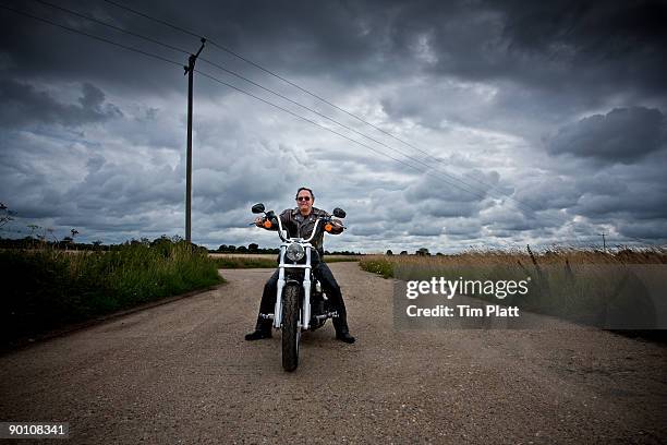 mature man on a motorcycle. - motorbike on road stock-fotos und bilder