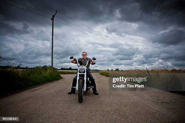 mature man on a motorcycle. - homem 55 anos imagens e fotografias de stock