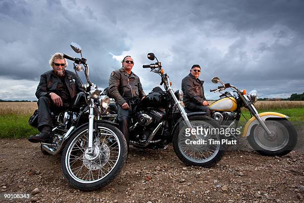 three men sitting on motorcycles. - only mature men stock pictures, royalty-free photos & images