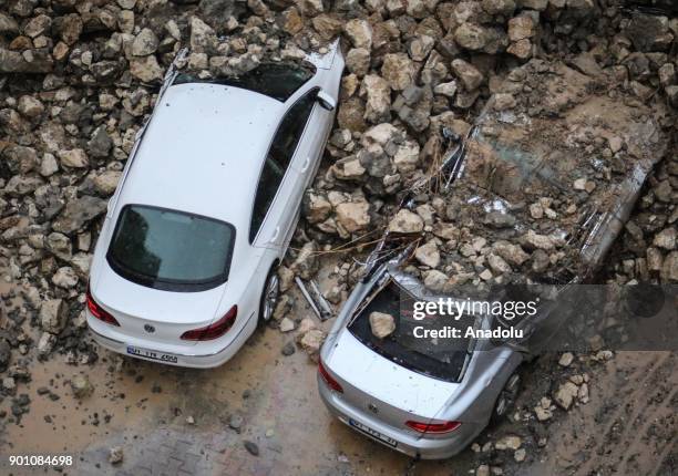 Damaged cars are seen following the collapse of a retaining wall due to heavy rain in Adana province of Turkey on January 4, 2018.