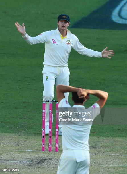 Steve Smith of Australia asks Mitch Starc if he wants a referral during day one of the Fifth Test match in the 2017/18 Ashes Series between Australia...