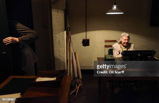 Veteran War Room shorthand typist Myra Collyer sits behind a typewriter in the Cabinet War Rooms bunker where she used to work during the second...