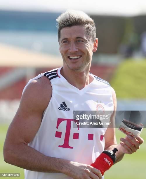 Robert Lewandowski smiles during a training session on day 3 of the FC Bayern Muenchen training camp at ASPIRE Academy for Sports Excellence on...