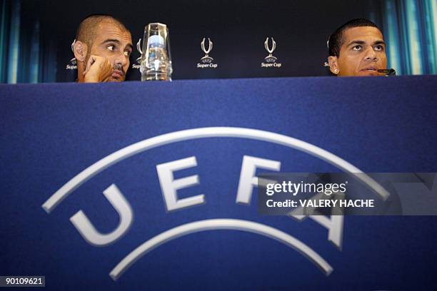 Barcelona's defender Dani Alves and coach Josep Guardiola speak during a press conference on the eve of their European Super Cup football match FC...