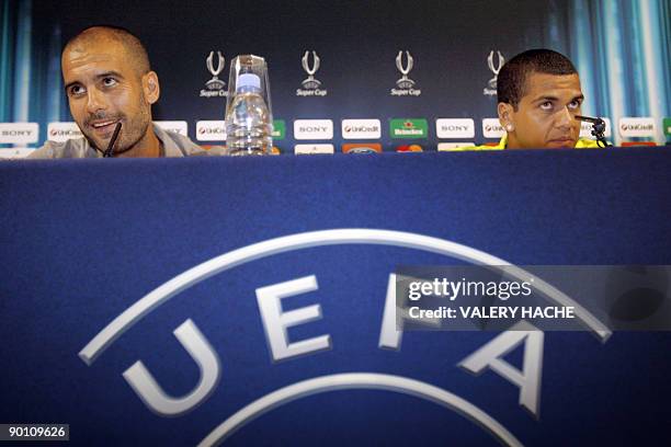 Barcelona's defender Dani Alves and coach Josep Guardiola speak during a press conference on the eve of their UEFA super cup football match FC...