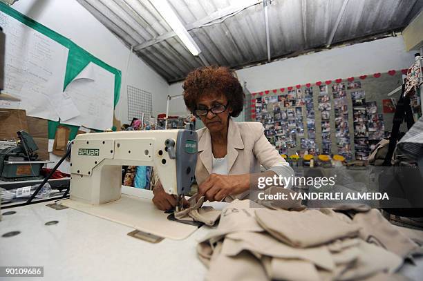 Brazilian 60 year-old seamstress Maria de Lourdes works at her atelier in Dona Marta shantytown, Rio de Janeiro, Brazil on August 25, 2009. Lourdes...