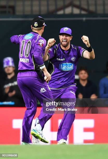 George Bailey of the Hobart Hurricanes celebrates after taking the wicket of Jake Weatherald of the Adelaide Strikers with Dan Christian of the...