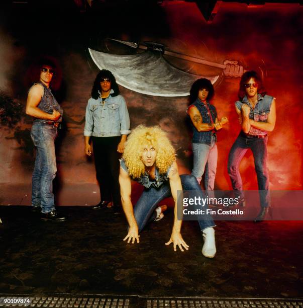 Posed group portrait of rock band Twisted Sister. Left to right are Mark Mendoza, Eddie Ojeda, Dee Snider, AJ Pero and JJ French taken in July 1982.