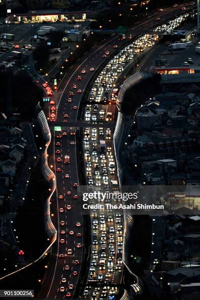 In this aerial image, long queue of cars are seen near the Tomei Expressway Ebina Service Area after people spent their New Year holidays at their...