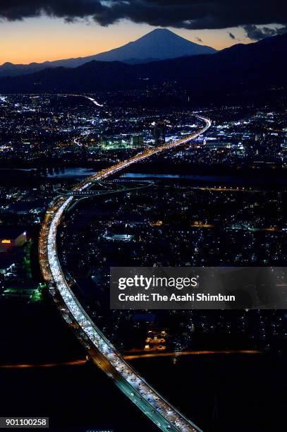 In this aerial image, long queue of cars are seen near the Tomei Expressway Ebina Service Area after people spent their New Year holidays at their...