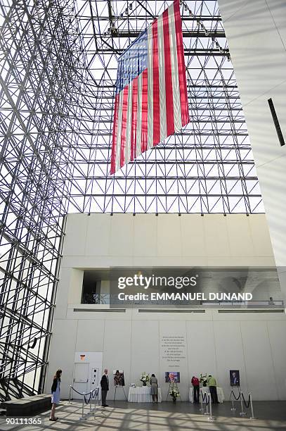 People sign a golden book in memory of the late US Senator Edward Kennedy at the John F. Kennedy Presidential Library and Museum where his body will...