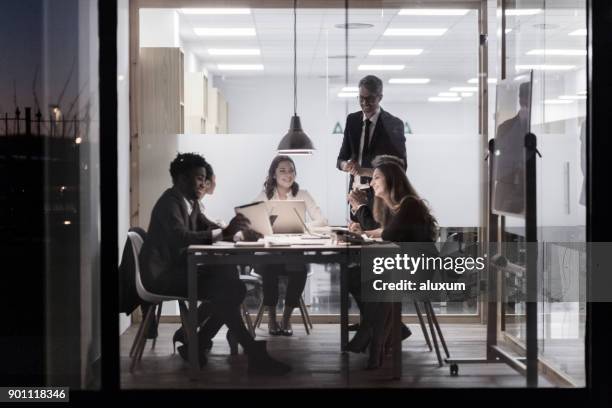 late business meeting in office cubicle - frosted glass stock pictures, royalty-free photos & images