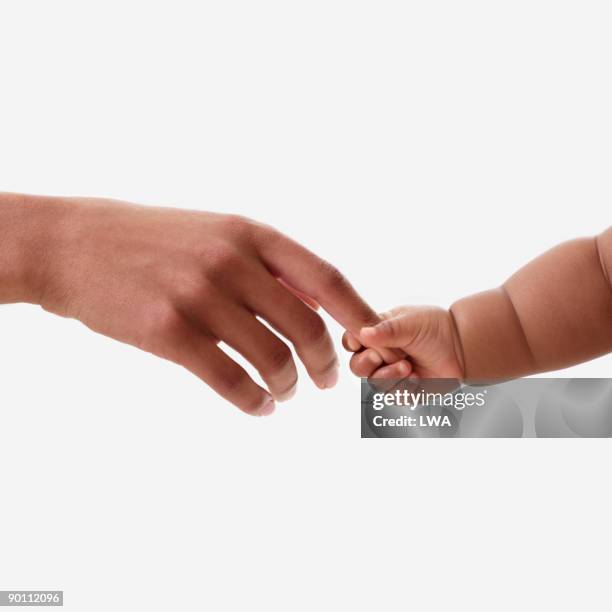 baby holding mother's finger - baby hands ストックフォトと画像