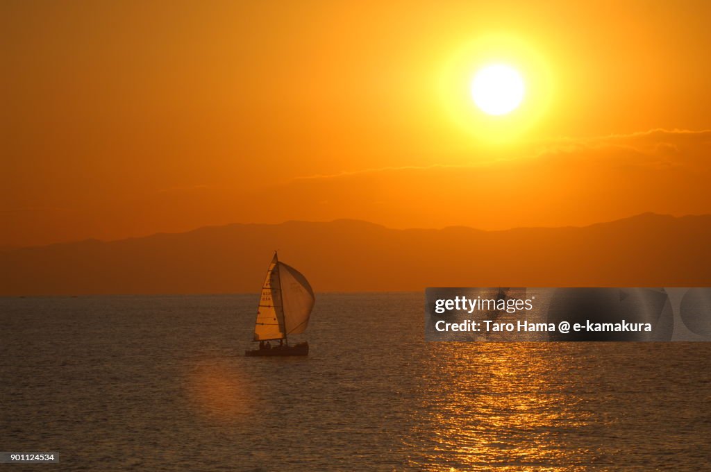 Evening sun on Izu Peninsula and a yacht on Sagami Bay in Kanagawa prefecture in Japan