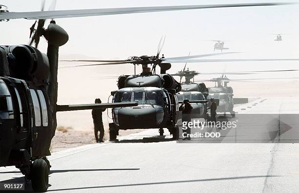 Black Hawk helicopters prepare to takeoff as the 82nd Aviation Brigade relocates in the desert during Operation Desert Shield.