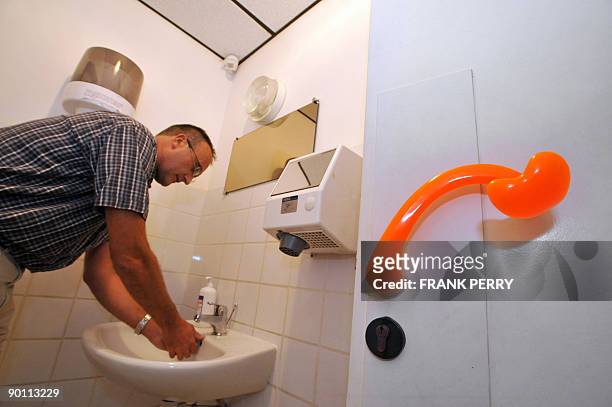 La grippe fait exploser les ventes d'une poignée de porte +anticontamination+" - A man washs his hands in toilets equiped with the first ergonomic...