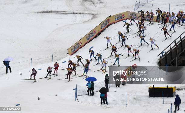 Skiers compete in the men's 15 kilometer Mass Start free style race of the "Tour de Ski" Cross Country World Cup on January 4, 2018 in Oberstdorf,...