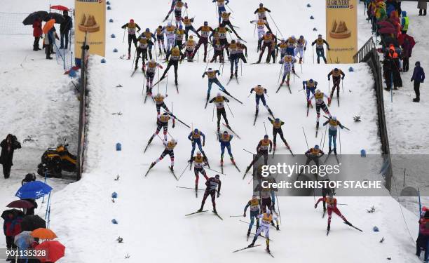 Skiers compete in the men's 15 kilometer Mass Start free style race of the "Tour de Ski" Cross Country World Cup on January 4, 2018 in Oberstdorf,...