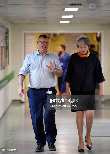 Prime Minister Theresa May with Frimley Health CEO Sir Andrew Morris at Frimley Park Hospital on January 4, 2018 in Frimley, England.