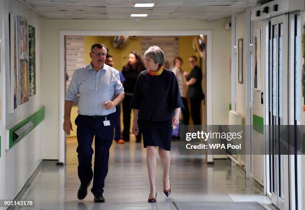 Prime Minister Theresa May with Frimley Health CEO Sir Andrew Morris at Frimley Park Hospital on January 4, 2018 in Frimley, England.