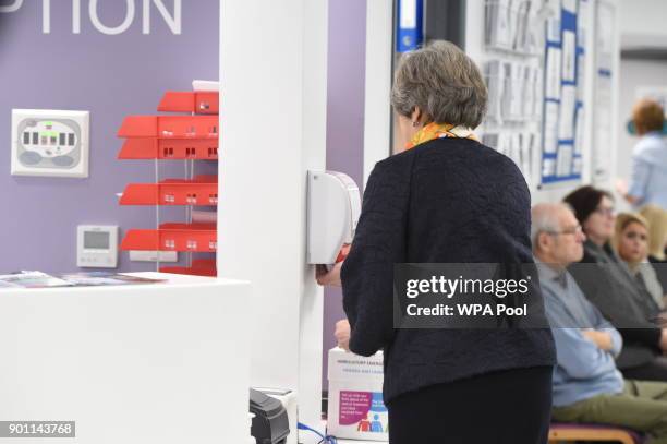 Prime Minister Theresa May washes her hands at Frimley Park Hospital on January 4, 2018 in Frimley, England.