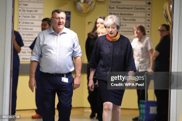 Prime Minister Theresa May with Frimley Health CEO Sir Andrew Morris at Frimley Park Hospital on January 4, 2018 in Frimley, England.