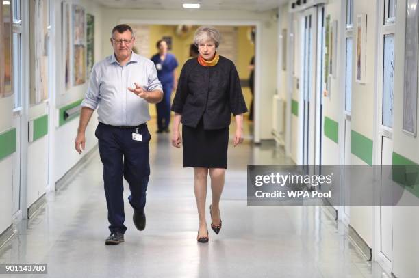 Prime Minister Theresa May with Frimley Health CEO Sir Andrew Morris at Frimley Park Hospital on January 4, 2018 in Frimley, England.