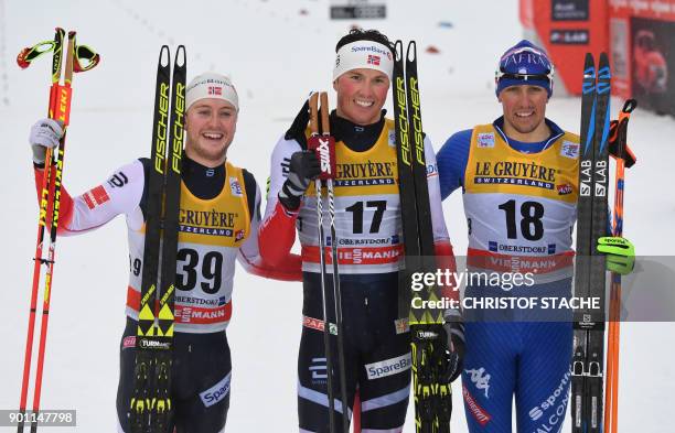 Norway's Sindre Bjoernestad Skar, Norway's Emil Iversen and Italy's Francesco De Fabiani pose at the end of the men's 15 kilometer Mass Start free...