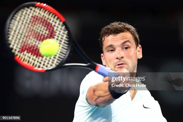 Grigor Dimitrov of Bulgaria plays a forehand in his match against John Millman of Australia during day five of the 2018 Brisbane International at Pat...