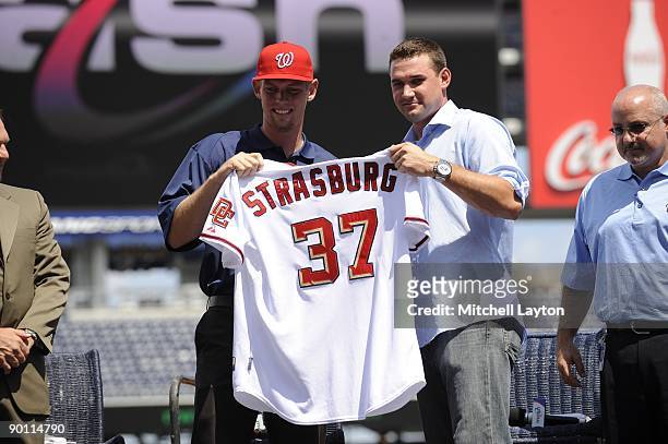Steven Strasburg and Ryan Zimmerman of the Washington Nationals pose for a photo, before Strasburg is introduced to the media, before a baseball game...