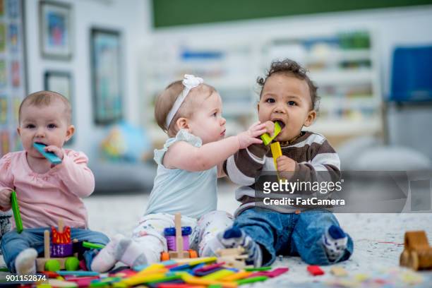 kids chewing on toys - baby playing stock pictures, royalty-free photos & images